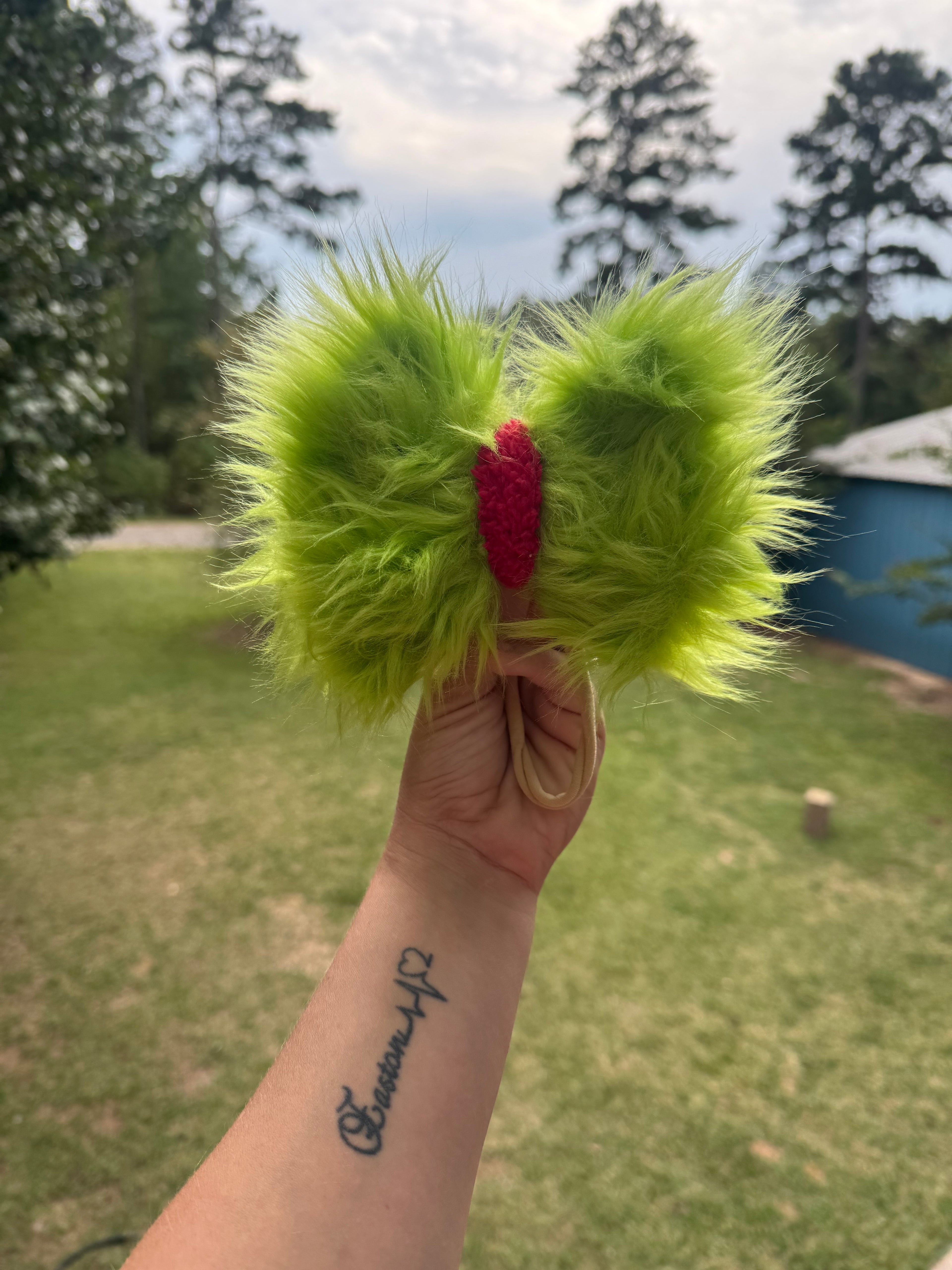 Green furry bow with red middle